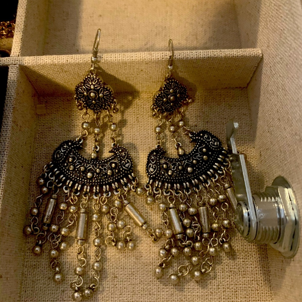 Long silver in color earrings